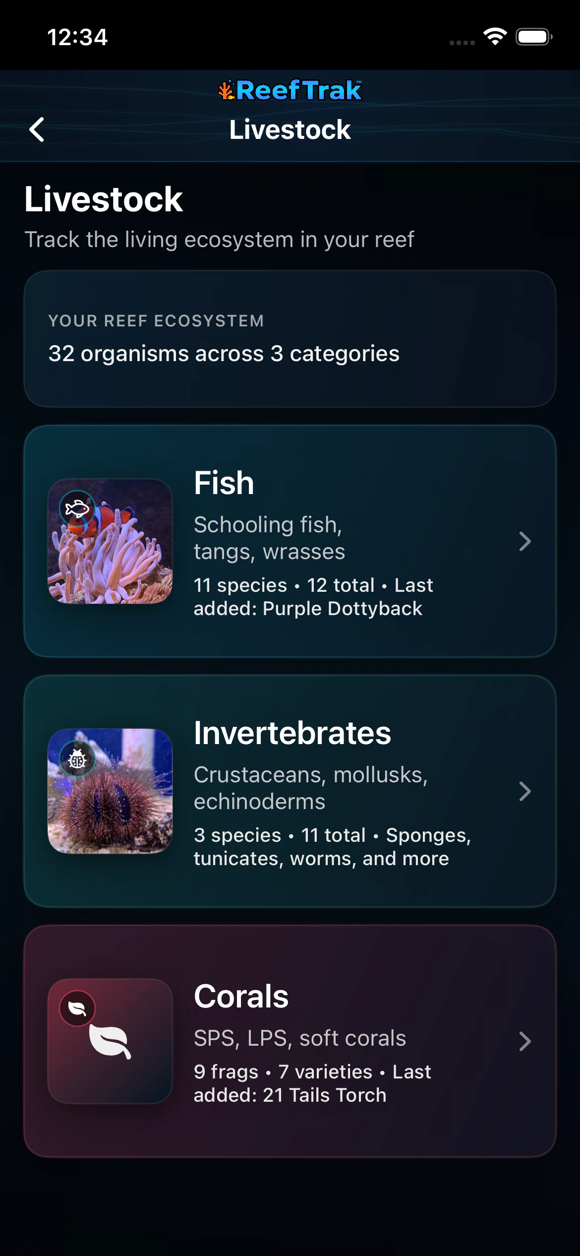 Reef Trak Livestock overview on iPhone showing 32 organisms across fish, invertebrate, and coral categories
