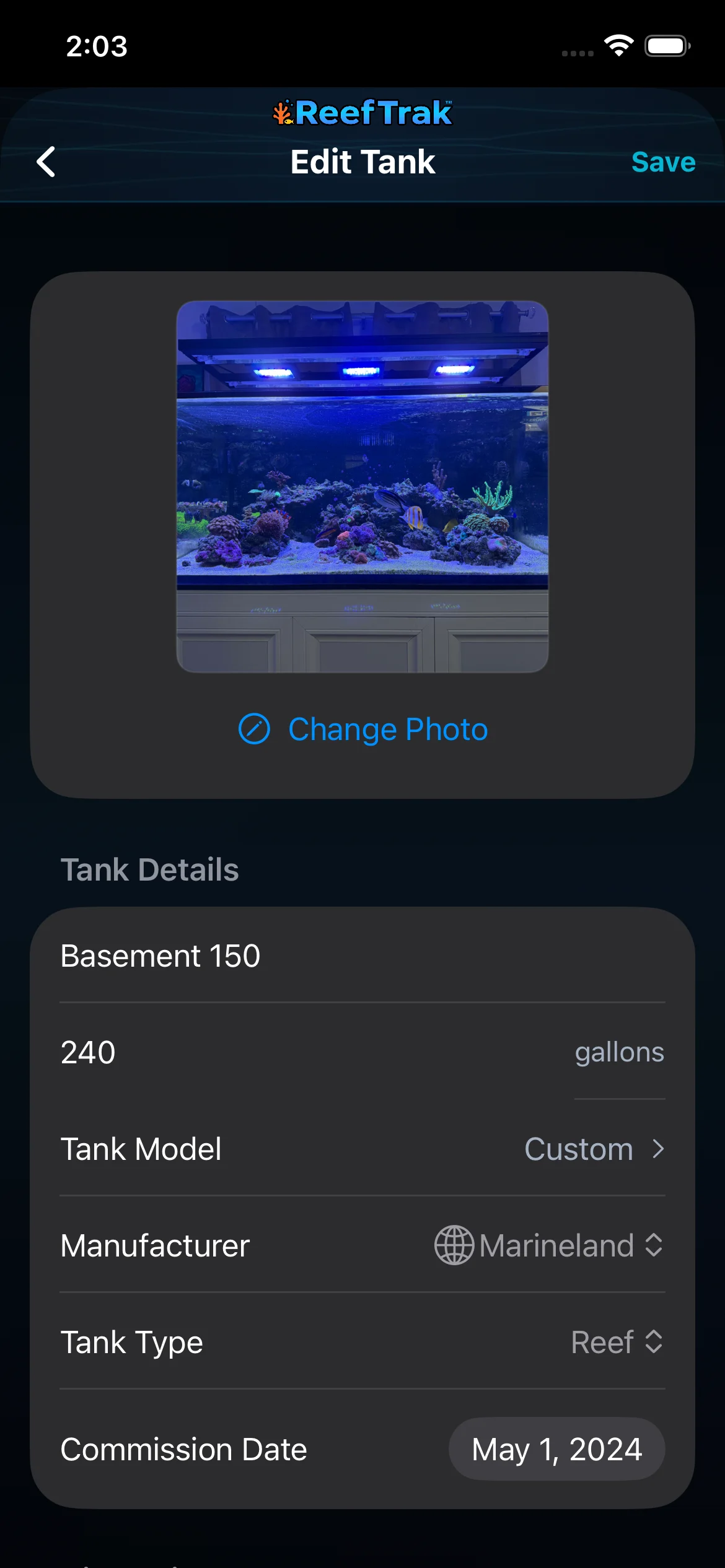 Reef Trak Edit Tank screen on iPhone showing the current aquarium photo, Change Photo control, tank details, and Save
